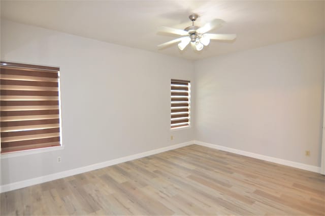 empty room with ceiling fan and light wood-type flooring