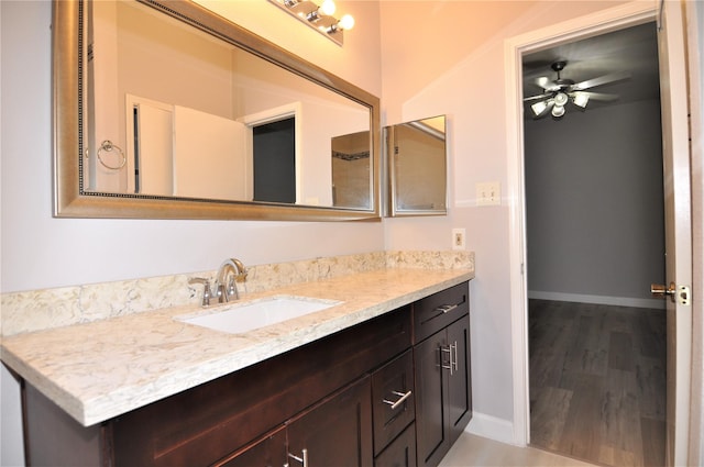 bathroom with vanity, hardwood / wood-style flooring, and ceiling fan