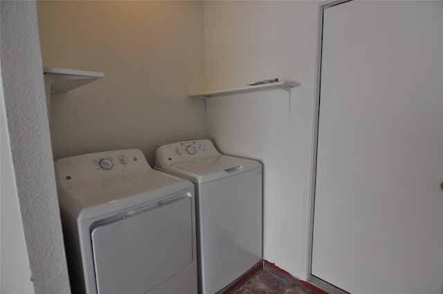 clothes washing area featuring washer and dryer