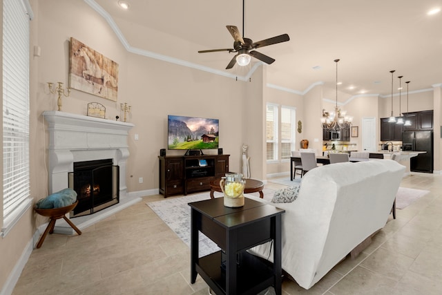 living room with light tile patterned floors, a lit fireplace, baseboards, and crown molding