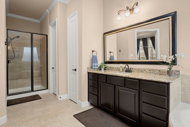 bathroom featuring baseboards, a garden tub, crown molding, vanity, and a shower stall