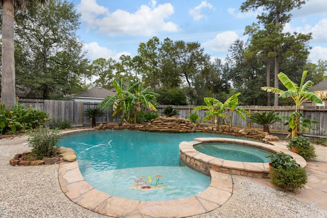 view of pool with an in ground hot tub