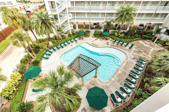 community pool featuring fence and a patio