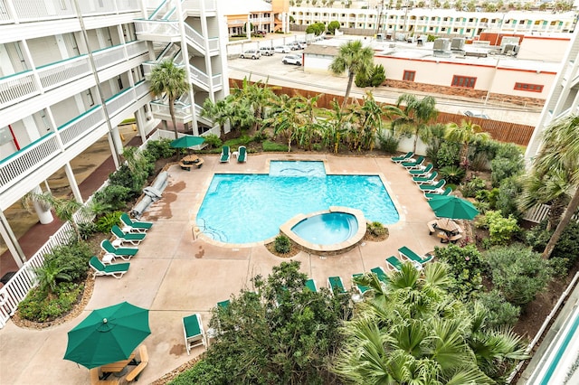 view of swimming pool with a patio area and a pool with connected hot tub