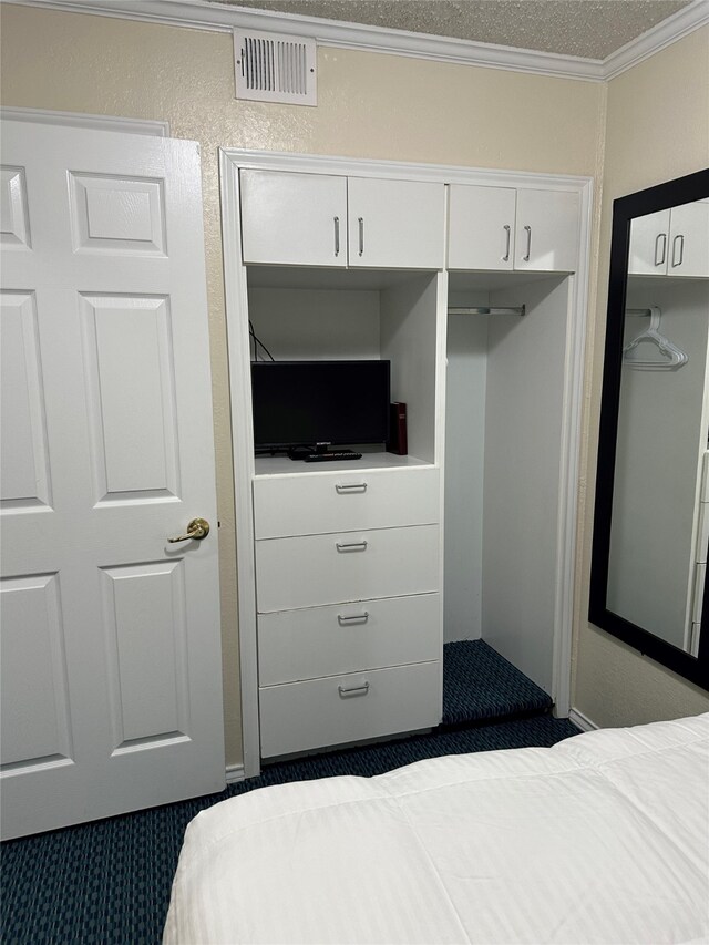 6102 Seawall Blvd Unit 128, Galveston, TX 77551 - bedroom featuring a textured ceiling, ornamental molding, and visible vents
