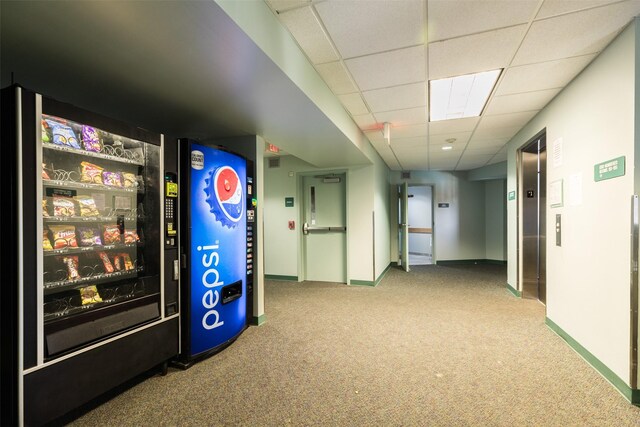 6102 Seawall Blvd Unit 128, Galveston, TX 77551 - corridor with carpet floors, elevator, a drop ceiling, and baseboards