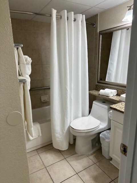 6102 Seawall Blvd Unit 128, Galveston, TX 77551 - bathroom with shower / tub combo, vanity, toilet, and tile patterned floors