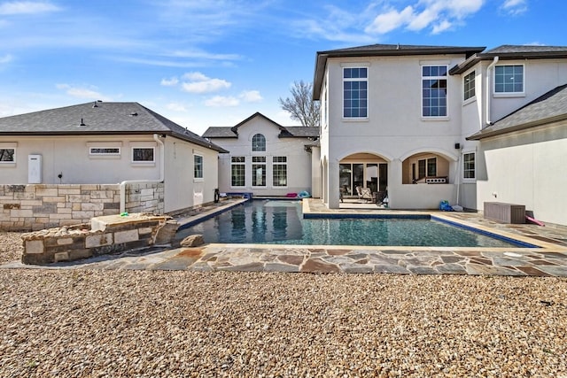 rear view of house with cooling unit and a patio