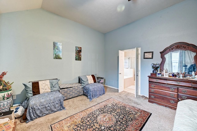 carpeted bedroom featuring vaulted ceiling and connected bathroom