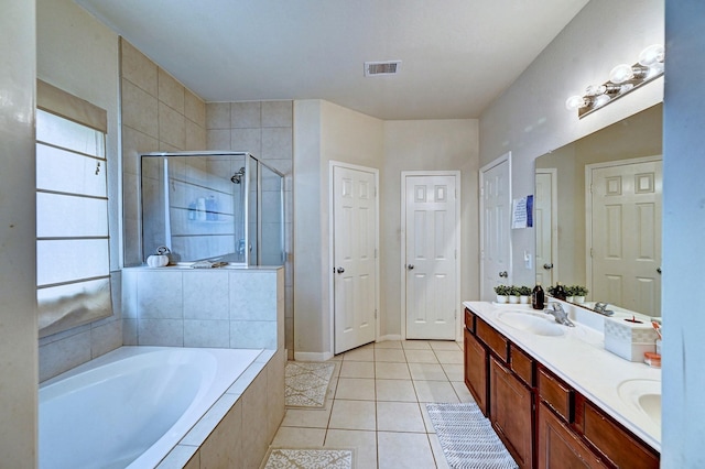 bathroom with tile patterned flooring, vanity, and shower with separate bathtub