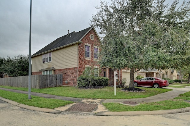 view of front of house featuring a garage and a front lawn