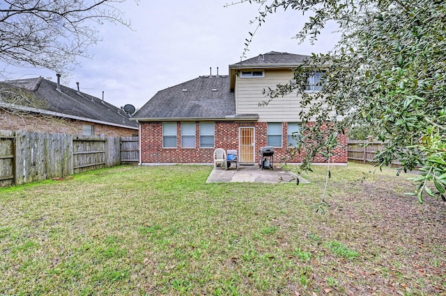 rear view of house featuring a yard and a patio area