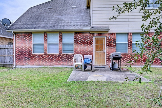 back of property featuring a patio and a lawn