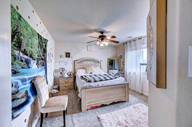 carpeted bedroom with a textured ceiling and ceiling fan