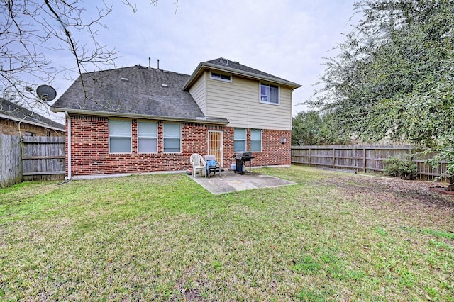 back of property featuring a yard and a patio area