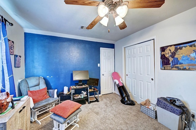 living area with ceiling fan and light carpet