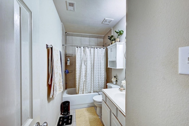 full bathroom featuring shower / tub combo with curtain, vanity, toilet, tile patterned floors, and a textured ceiling