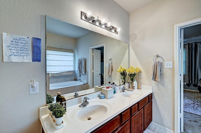 bathroom with vanity and a washtub