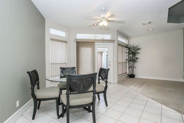 carpeted dining room featuring ceiling fan