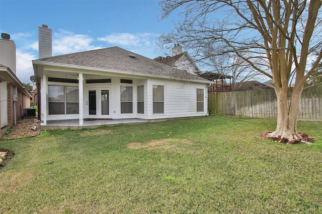 rear view of house featuring a yard, central air condition unit, and a patio area