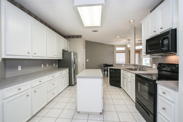 kitchen with a center island, white cabinets, and black appliances