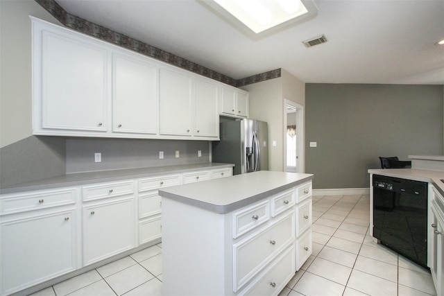 kitchen with a center island, stainless steel fridge with ice dispenser, light tile patterned floors, black dishwasher, and white cabinets