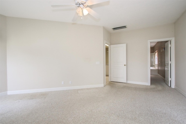 unfurnished bedroom with connected bathroom, light colored carpet, and ceiling fan