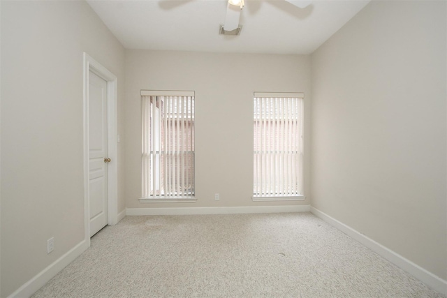 unfurnished room featuring light carpet and ceiling fan