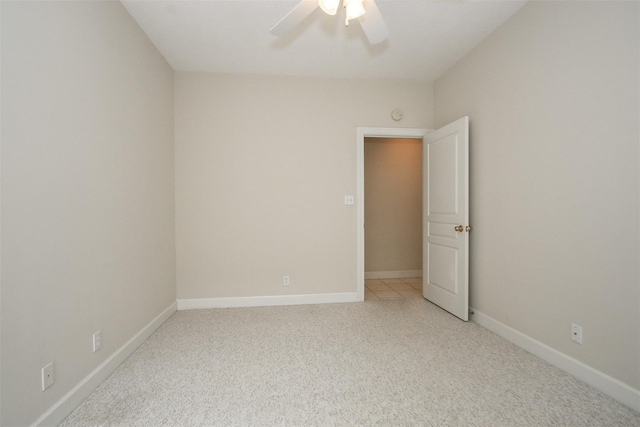 spare room with light colored carpet and ceiling fan