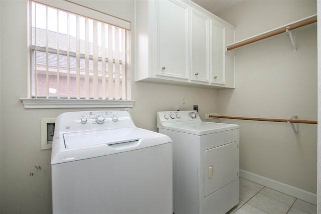 laundry room featuring independent washer and dryer, cabinets, and light tile patterned floors