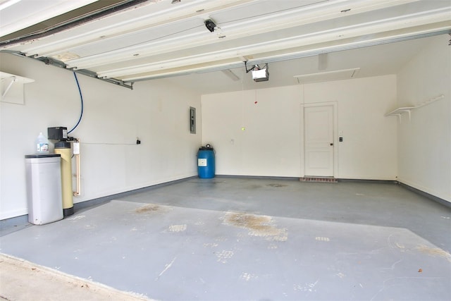 garage with a garage door opener and electric panel