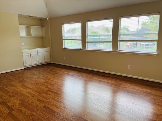 empty room with dark hardwood / wood-style floors