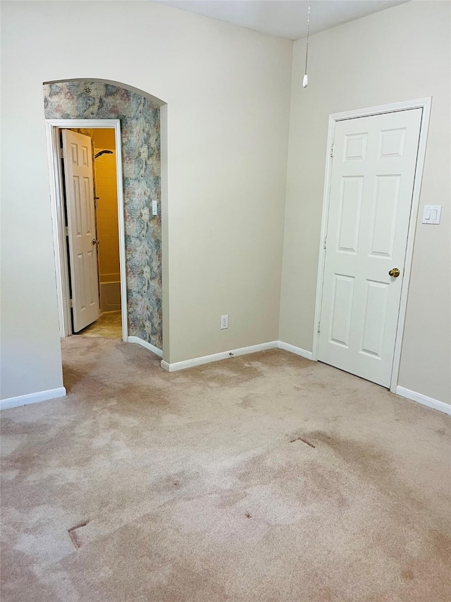 unfurnished room with light carpet