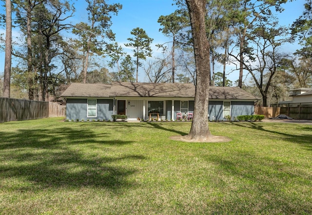 back of property with fence and a yard