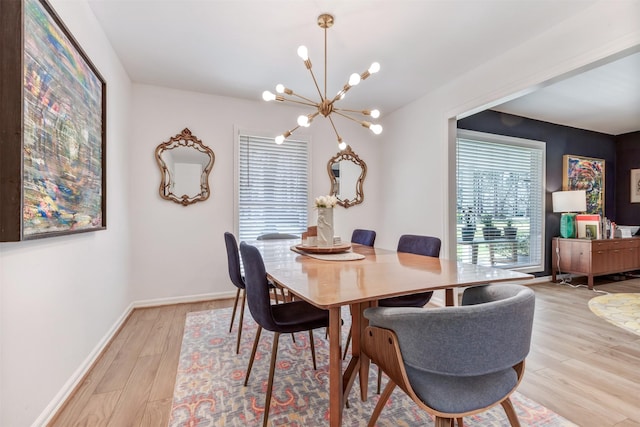 dining area featuring a chandelier, light wood-type flooring, and baseboards