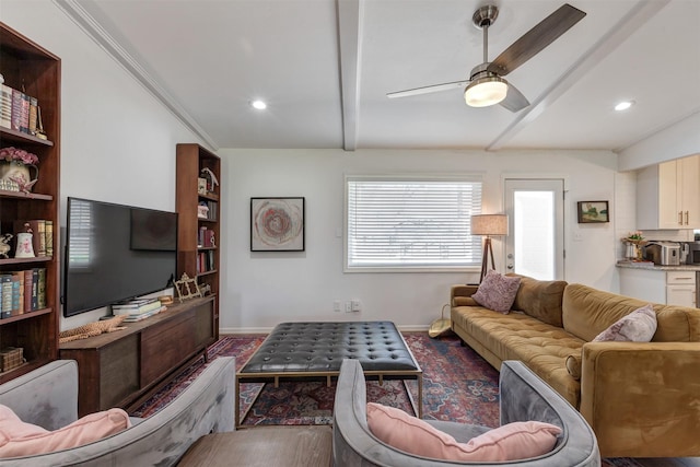 living area with baseboards, a ceiling fan, beamed ceiling, and recessed lighting