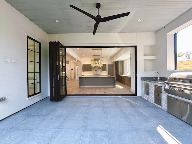 view of patio / terrace with an outdoor kitchen, a grill, and ceiling fan