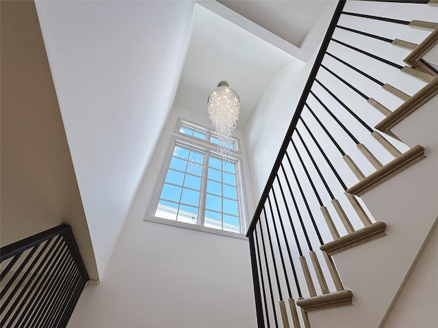 stairway featuring an inviting chandelier