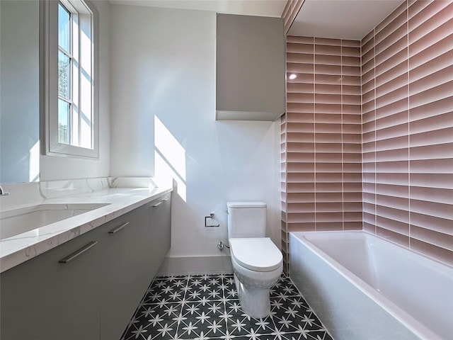 bathroom with vanity, toilet, and a washtub