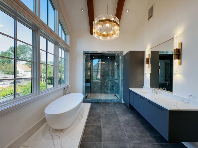 bathroom featuring an inviting chandelier, vanity, plus walk in shower, and a high ceiling