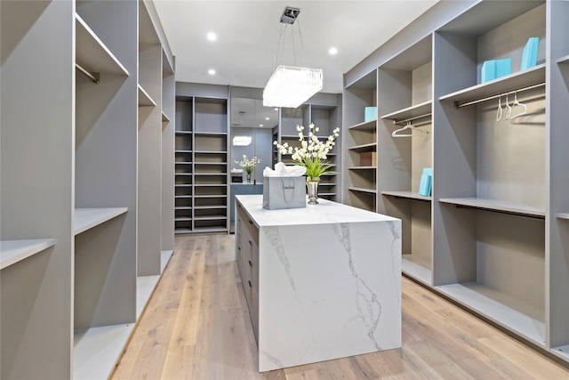 spacious closet featuring light hardwood / wood-style flooring