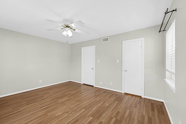 unfurnished bedroom with light hardwood / wood-style flooring and ceiling fan