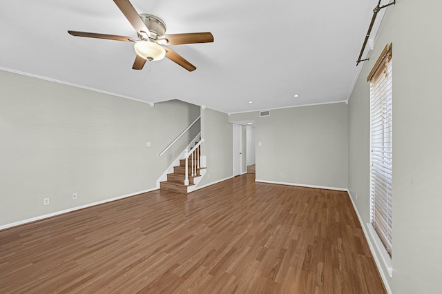 unfurnished living room with ornamental molding, hardwood / wood-style floors, and ceiling fan