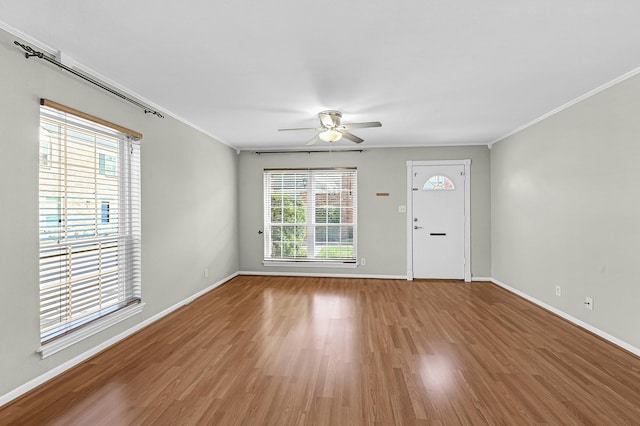 interior space featuring crown molding, wood-type flooring, and ceiling fan