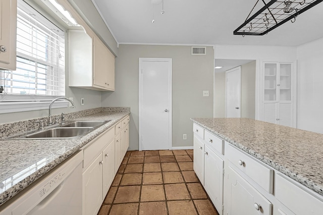 kitchen featuring light stone countertops, sink, white cabinets, and white dishwasher