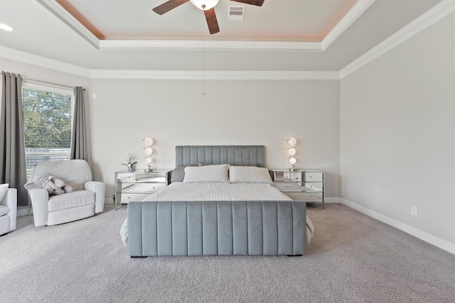 bedroom with a raised ceiling, ornamental molding, light colored carpet, and ceiling fan