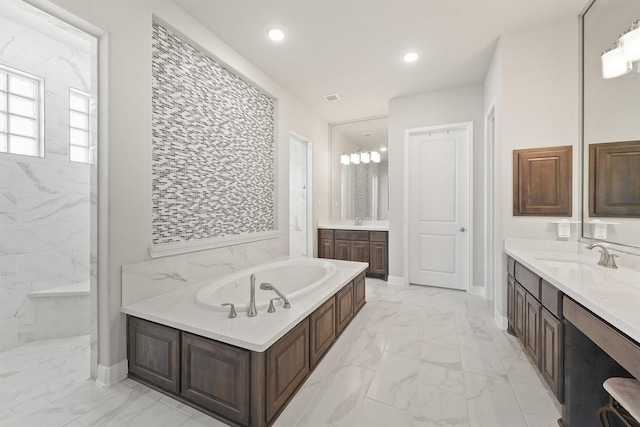 bathroom with vanity and a washtub