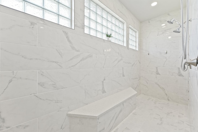 bathroom featuring plenty of natural light and a tile shower