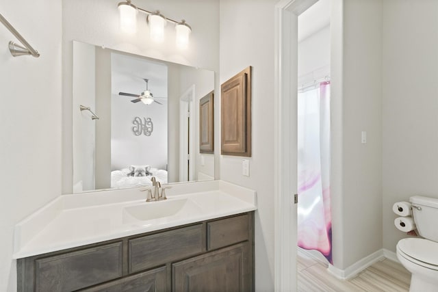 bathroom with vanity, toilet, and curtained shower