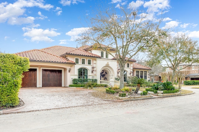 mediterranean / spanish home with a garage